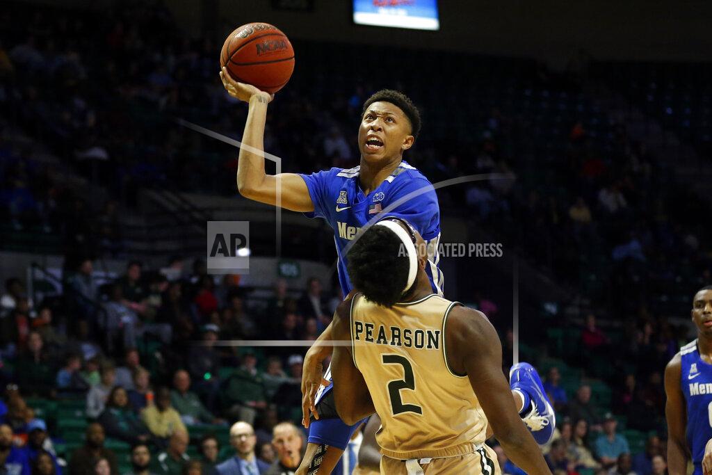 Butch Dill UAB forward Tamell Pearson (2) draws the charge as Memphis guard Boogie Ellis (5) puts up a shot during the second half of an NCAA college basketball game Saturday, Dec. 7, 2019, in Birmingham, Ala. (AP Photo/Butch Dill)