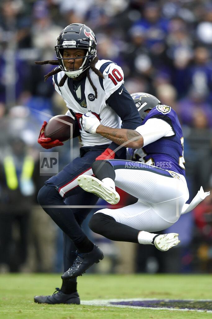 Gail Burton Houston Texans wide receiver DeAndre Hopkins (10) tries to stay up as Baltimore Ravens cornerback Jimmy Smith (22) wraps him up during the first half of an NFL football game, Sunday, Nov. 17, 2019, in Baltimore. (AP Photo/Gail Burton)
