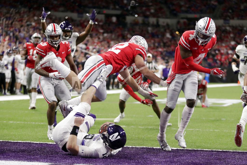Michael Conroy Northwestern quarterback Clayton Thorson, bottom, falls into the end zone at the end of a touchdown during the second half of the Big Ten championship NCAA college football game against Ohio State, Saturday, Dec. 1, 2018, in Indianapolis. (AP Photo/Michael Conroy)