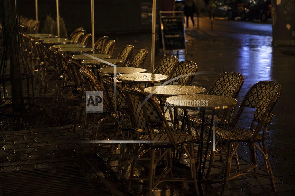 Lewis Joly An empty terrace in Paris, Monday, Oct. 5, 2020. French authorities have placed the Paris region on maximum virus alert on Monday, banning festive gatherings and requiring all bars to close but allowing restaurants to remain open, as numbers of infections are rapidly increasing. (AP Photo/Lewis Joly)