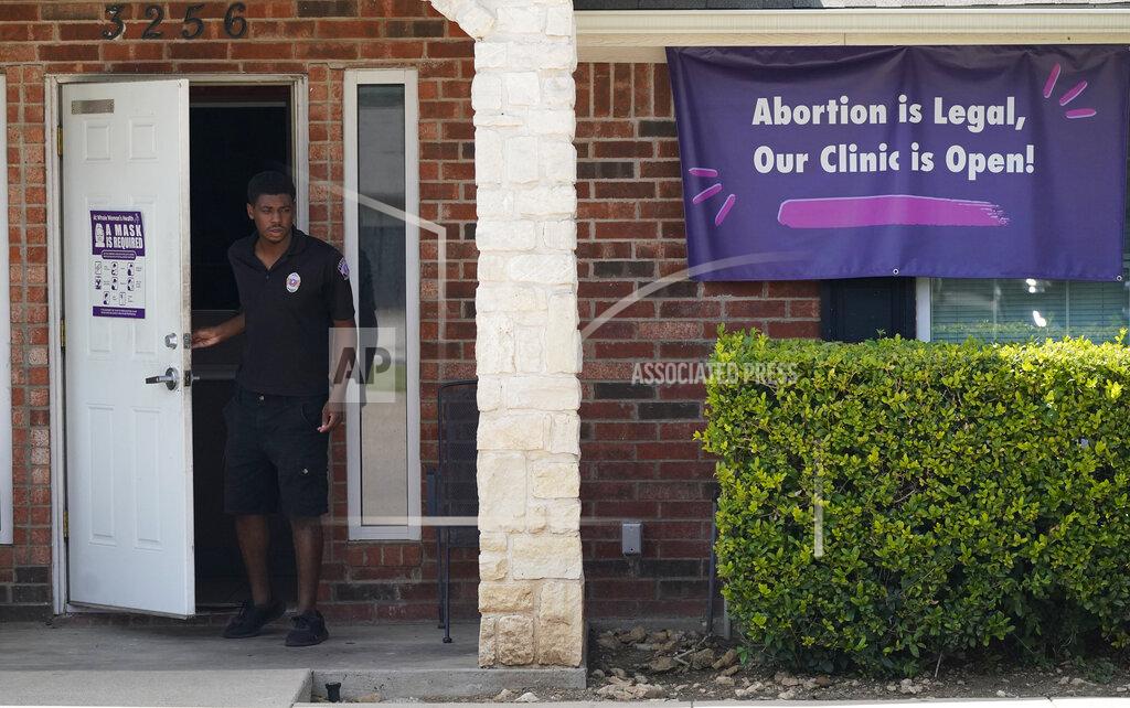 Lm Otero FILE - In this Wednesday, Sept. 1, 2021 file photo, a security guard opens the door to the Whole Women's Health Clinic in Fort Worth, Texas. A Texas law banning most abortions in the state took effect at midnight. (AP Photo/LM Otero, File)