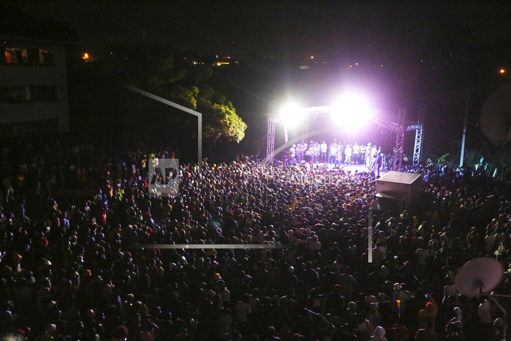 Tsvangirayi Mukwazhi Thousands of people attend a music concert to celebrate New Year's in the Mbare suburb of Harare, Zimbabwe, early Friday, Jan 1, 2021. Despite a government ban on music concerts and public gatherings due to a surge in COVID-19 infections and the new and more contagious variants of the disease, thousands of people gathered in one of the country's poorest neighborhoods to celebrate the new year. (AP Photo/Tsvangirayi Mukwazhi)