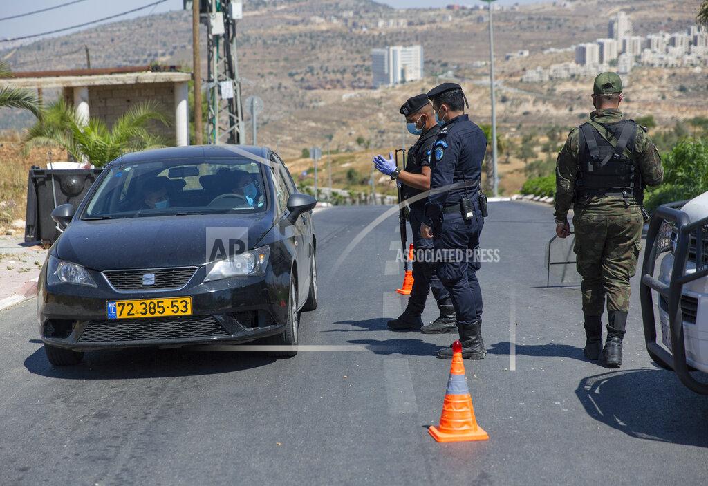 Nasser Nasser A Palestinian security unit mans a checkpoint at an entrance of in the West Bank city of Ramallah, Thursday, July 2, 2020. The Palestinian Authority has announced a five-day total lockdown in the West Bank starting Friday, in response to a major increase in coronavirus cases and deaths in recent days. (AP Photo/Nasser Nasser)