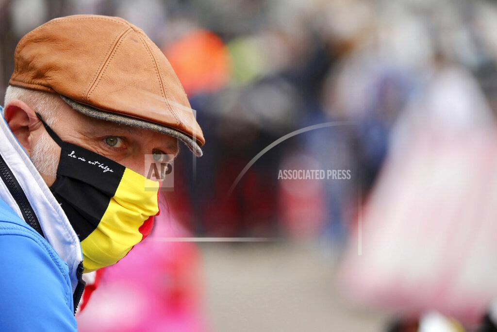 A spectator wears a protective mask as he watches the Belgian cycling classic and UCI World Tour race Fleche Wallonne, in Huy, Belgium, Wednesday, Sept. 30, 2020. (AP Photo/Olivier Matthys)