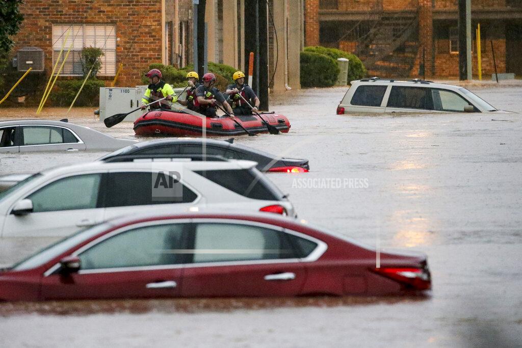 Butch Dill Residents of the Crescent at Lakeshore apartment complex are rescued by Homewood Fire and Rescue as severe weather produced torrential rainfall flooding several apartment buildings Tuesday, May 4, 2021 in Homewood, Ala. (AP Photo/Butch Dill)