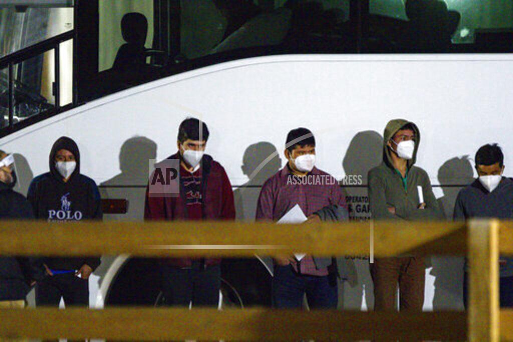 Eli Hartman FILE - In this Sunday, March 14, 2021, file photo, migrant children and teenagers from the southern border of the United States wait to be processed after entering the site of a temporary holding facility south of Midland, Texas. The Biden administration is not requiring FBI fingerprint background checks of caregivers at its rapidly expanding network of emergency sites to hold thousands of immigrant teenagers. That alarms child welfare experts who say the waiver compromises safety. (Eli Hartman/Odessa American via AP, File)