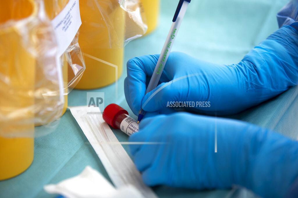 Manu Fernandez A health worker takes a sample for a PCR test for the COVID-19 coronavirus at a hospital in Coslada, Spain, Monday, April 20, 2020. The Spanish government is starting to relax its confinement measures due to the COVID-19 coronavirus outbreak, trying to re-activate the economy after a two-week freeze and allowing children under 12 years-old to venture out to the streets for brief periods from next week. (AP Photo/Manu Fernandez)