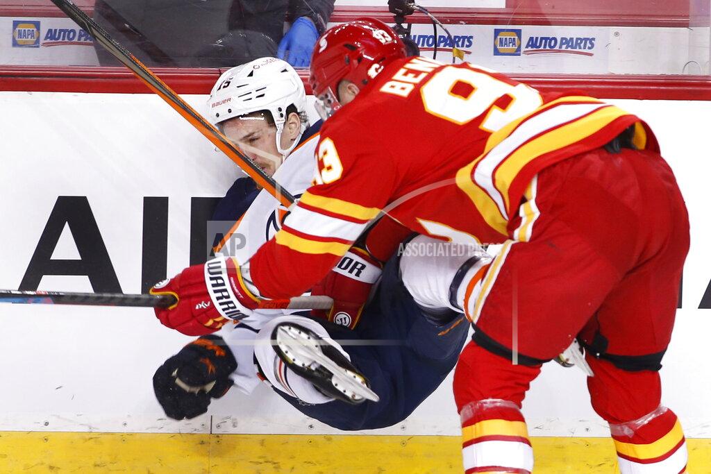 Larry Macdougal Edmonton Oilers' Josh Archibald, left, takes a hit from Calgary Flames' Sam Bennett during the first period of an NHL hockey game Saturday, April 10, 2021, in Calgary, Alberta. (Larry MacDougal/The Canadian Press via AP)