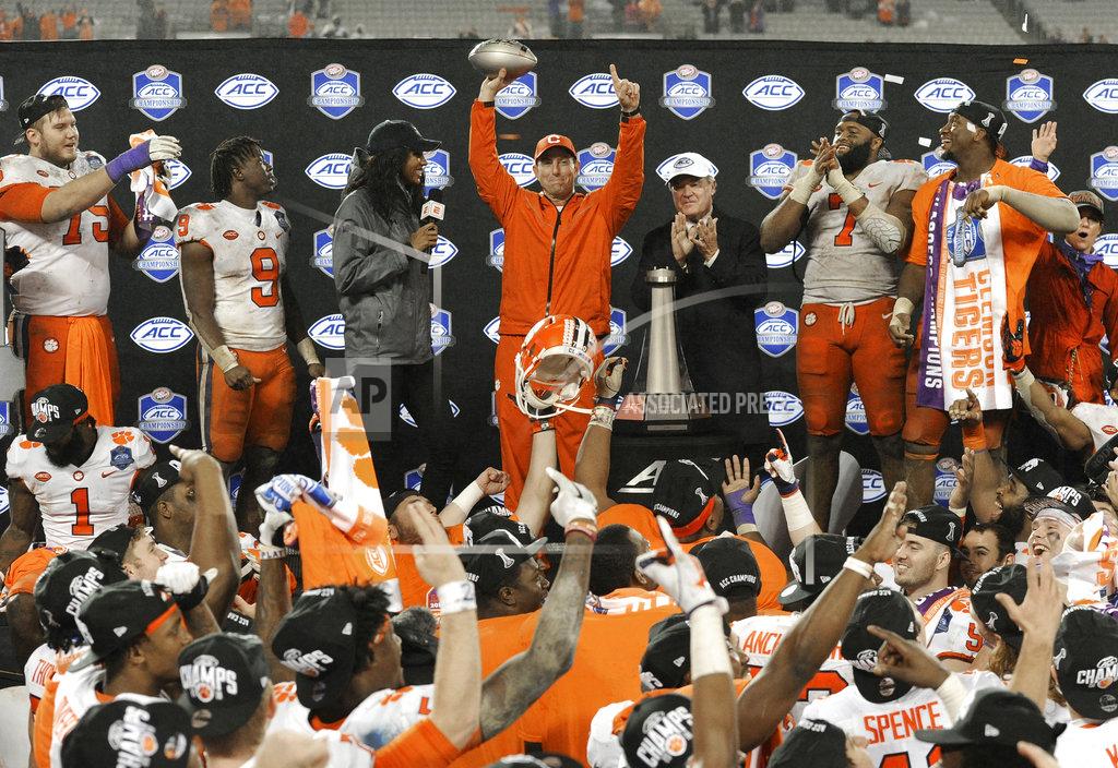 Mike Mccarn Clemson head coach Dabo Swinney raises the trophy after Clemson won the Atlantic Coast Conference championship NCAA college football game against Pittsburgh in Charlotte, N.C., Saturday, Dec. 1, 2018. (AP Photo/Mike McCarn)