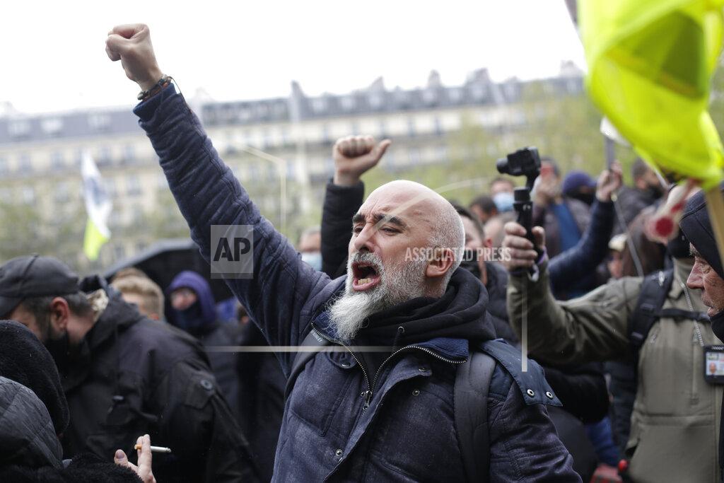 Thibault Camus A worker raises his fist during May Day demonstration, Saturday, May 1, 2021 in Paris. Workers and union leaders dusted off bullhorns and flags that had stayed furled during coronavirus lockdowns for slimmed down but still boisterous May Day marches on Saturday, demanding more labor protections amid a pandemic that has turned economies and workplaces upside down. (AP Photo/Thibault Camus)