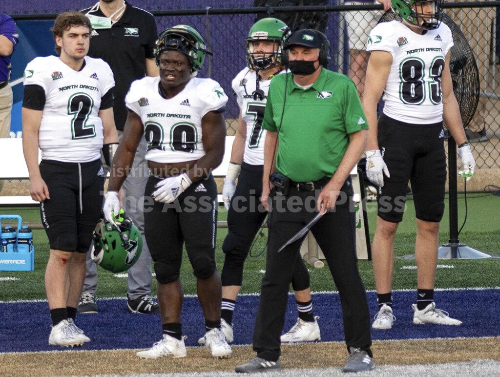 North Dakota head coach Bubba Schweigert watches his team from their sideline during the first half of a quarterfinal game against James Madison in the NCAA FCS football playoffs in Harrisonburg, Va., Sunday, May 2, 2021. (Daniel Lin/Daily News-Record via AP)