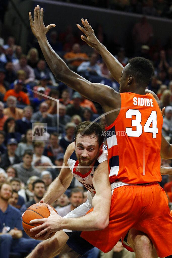 Steve Helber Virginia forward Jay Huff, left, tries to get around Syracuse forward Bourama Sidibe (34) during the second half of an NCAA college basketball game in Charlottesville, Va., Saturday, Jan. 11, 2020. Syracuse defeated Virginia 63-55 in overtime. (AP Photo/Steve Helber)