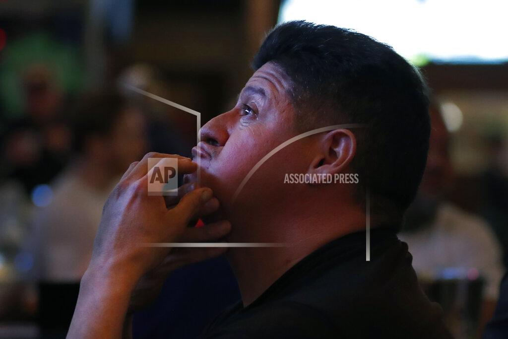 Shafkat Anowar Chicago resident Frank Robelli reacts while watching one the many television screens at Lottie's Pub in Chicago's Bucktown neighborhood on Saturday, March 13, 2021. Bars and restaurants that were shuttered for months due to the pandemic have reopened their doors just in time for the NCAA basketball tournament. (AP Photo/Shafkat Anowar)