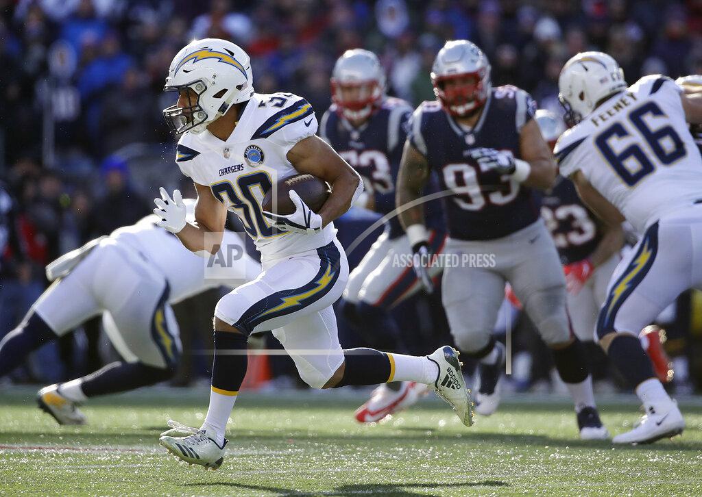 Elise Amendola Los Angeles Chargers running back Austin Ekeler (30) gains yardage against the New England Patriots during the first half of an NFL divisional playoff football game, Sunday, Jan. 13, 2019, in Foxborough, Mass. (AP Photo/Elise Amendola)