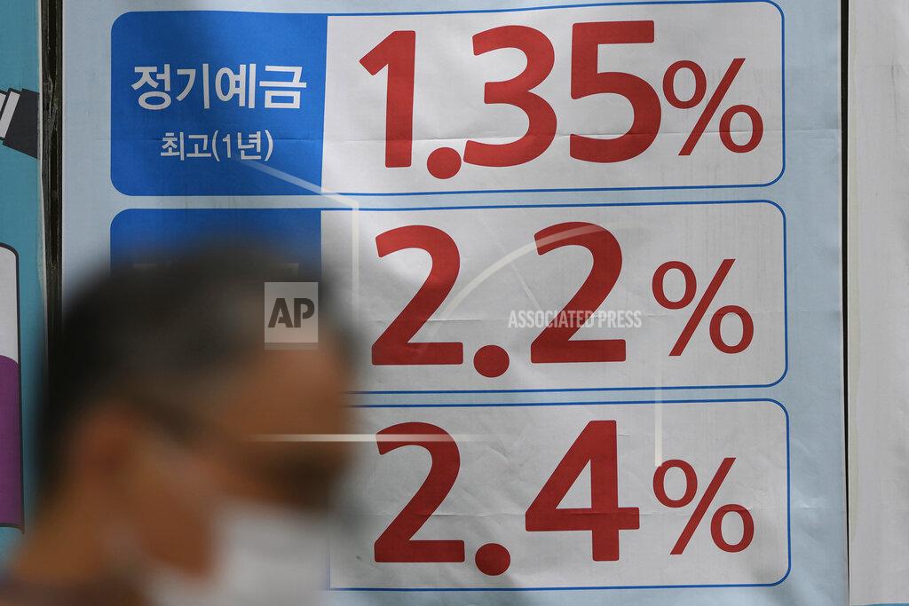 Lee Jin-Man A man walks near an advertisement showing bank's interest rates in downtown Seoul, South Korea, Friday, Sept. 17, 2021. Asian shares were mixed on Friday after a hodge-podge of economic data led Wall Street to close mostly lower. (AP Photo/Lee Jin-man)