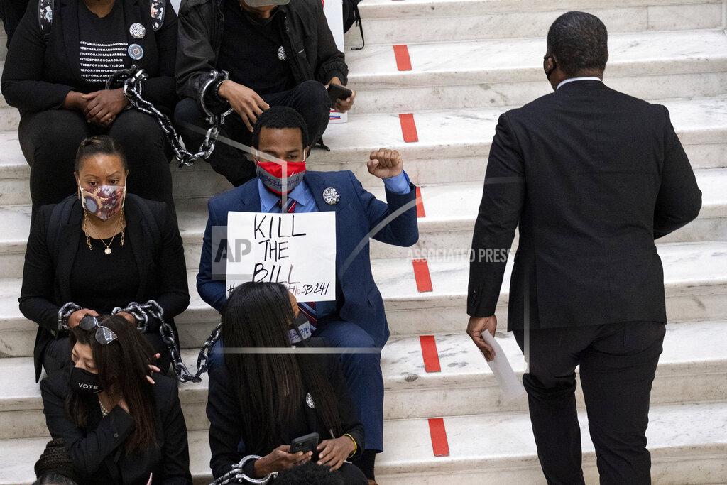 Ben Gray Protesters opposed to changes in Georgia's voting laws sit on the steps inside the State Capitol in Atlanta, Ga., as the Legislature meets Monday, March 8, 2021, in Atlanta. (AP Photo/Ben Gray)