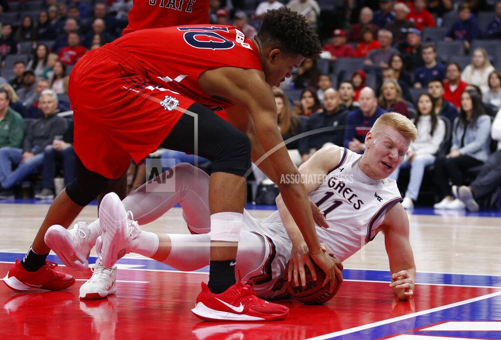 Rich Pedroncelli Fresno State forward Orlando Robinson, left, and Saint Mary's forward Matthias Tass, right, scramble for the ball during the first half of an NCAA college basketball game in Sacramento, Calif., Wednesday, Nov. 20, 2019. (AP Photo/Rich Pedroncelli)