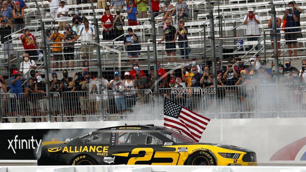 Charles Krupa Driver Brad Keselowski celebrates with a burnout and the American flag after winning during a NASCAR Cup Series auto race, Sunday, Aug. 2, 2020, at the New Hampshire Motor Speedway in Loudon, N.H. (AP Photo/Charles Krupa)