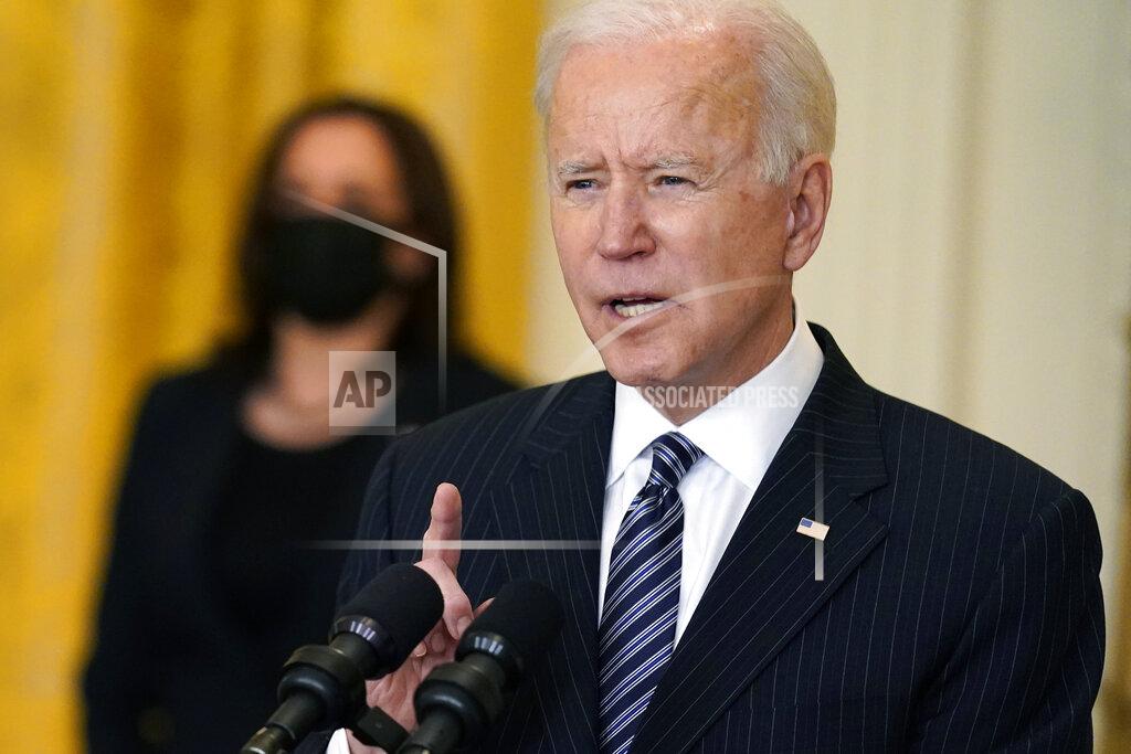 Andrew Harnik President Joe Biden speaks about COVID-19 vaccinations, from the East Room of the White House, Thursday, March 18, 2021, in Washington, as Vice President Kamala Harris listens. (AP Photo/Andrew Harnik)