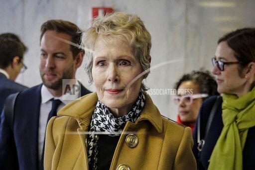 FILE - E. Jean Carroll, center, waits to enter a courtroom in New York for her defamation lawsuit against President Donald Trump, March 4, 2020. At a hearing Friday, Dec. 3, 2021, lawyers for former President Trump argued before a federal appeals court that the U.S. government should take his place as the defendant in the lawsuit filed by Carroll, who accused him of rape. (AP Photo/Seth Wenig, File)