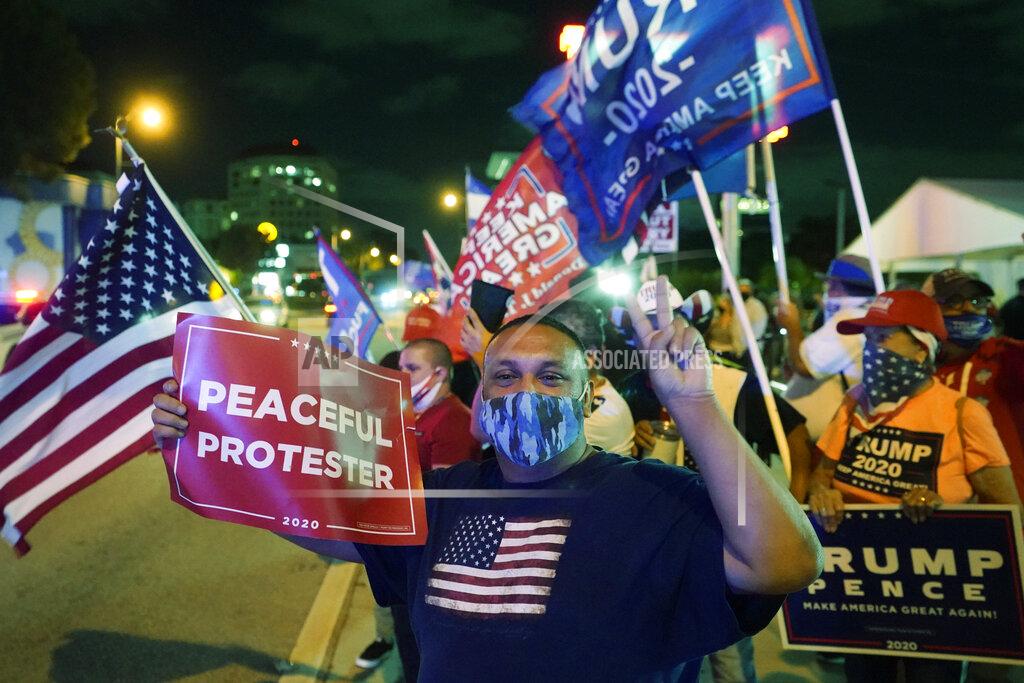 Wilfredo Lee Supporters of President Donald Trump chant and wave flags outside the Versailles Cuban restaurant during an Election Night celebration, Tuesday, Nov. 3, 2020, in the Little Havana neighborhood of Miami. Trump and his Republican allies made significant inroads with Latino voters in Tuesday’s election, alarming some Democrats who warned that immigration politics alone was not enough to hold their edge with the nation’s largest minority group. (AP Photo/Wilfredo Lee)