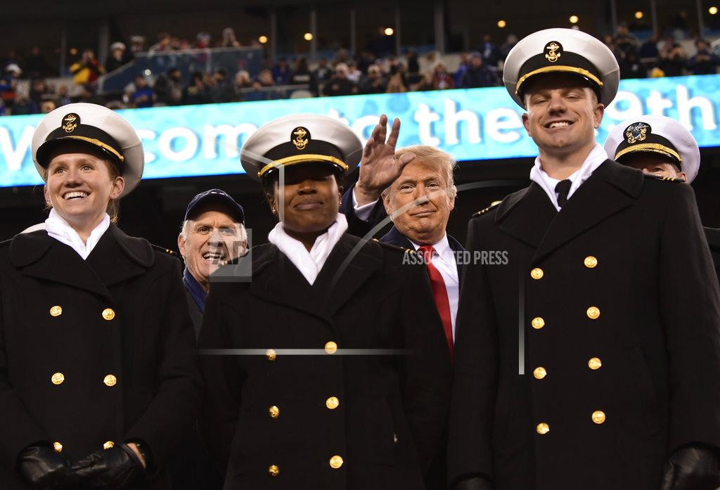 Susan Walsh President Donald Trump, background center, standing with Navy Secretary Richard Spencer, second from left, and Naval Academy Superintendent Vice Adm. Ted Carter, background right, watch the second half of the Army-Navy football game in Philadelphia, Saturday, Dec. 8, 2018. (AP Photo/Susan Walsh)