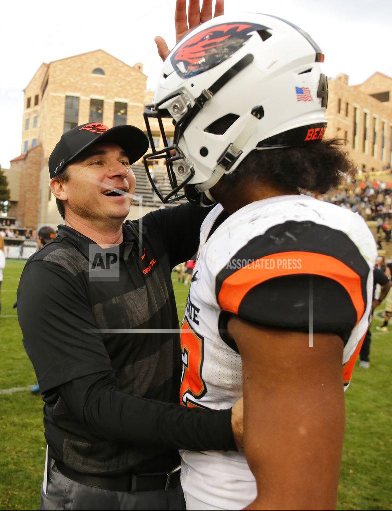Jack Dempsey Oregon State head coach Jonathan Smith congratulates Doug Taumoelau (42) following the team's overtime win against Colorado during an NCAA football game, Saturday, Oct. 27, 2018, in Boulder, Colo. (AP Photo/Jack Dempsey)