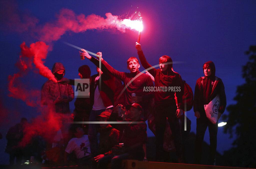 Martin Rickett Liverpool fans celebrate outside Anfield stadium after the English Premier soccer match between Liverpool and Chelsea, Wednesday, July 22, 2020, in Liverpool, England. (Martin Rickett/PA via AP)