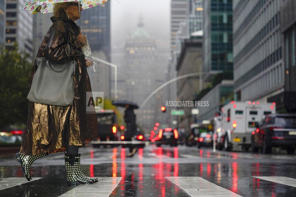Seth Wenig Pedestrians make their way through a rainy and foggy New York, Tuesday, Oct. 26, 2021. (AP Photo/Seth Wenig)