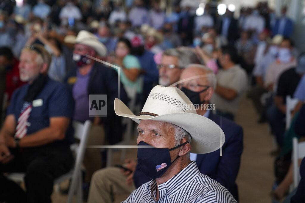 Evan Vucci People listen as President Donald Trump delivers remarks about American energy production during a visit to the Double Eagle Energy Oil Rig, Wednesday, July 29, 2020, in Midland, Texas. (AP Photo/Evan Vucci)