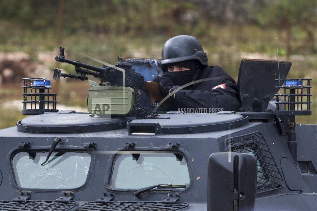 Uncredited A member of the police forces of Bosnia's Serb-run part mans a machine gun during exercises on the Jahorina Mountain, Bosnia and Herzegovina, Friday, Oct. 22, 2021. The exercises on Jahorina Mountain, outside Sarajevo, and in the northern town of Mrkonjic Grad, were staged just days after Bosnian Serb top leader, Milorad Dodik, announced that the country's Serb-run part will quit the key multi-ethnic state institutions. (AP Photo)