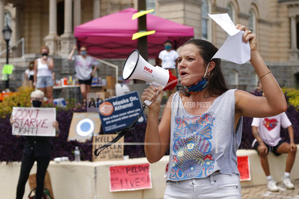 Joshua L. Jones Amelia Wheeler of the United Campus Workers speaks during a "Don't Starve Fight Day of Action" demonstration and food drive at City Hall on Tuesday, Sept. 1, 2020, in Athens, Ga. Demonstrators called on Sen. Kelly Loeffler R-Ga., and other politicians to act and protect workers' lives and livelihoods by extending the $600 unemployment benefit which ended in July. (Joshua L. Jones/Athens Banner-Herald via AP)
