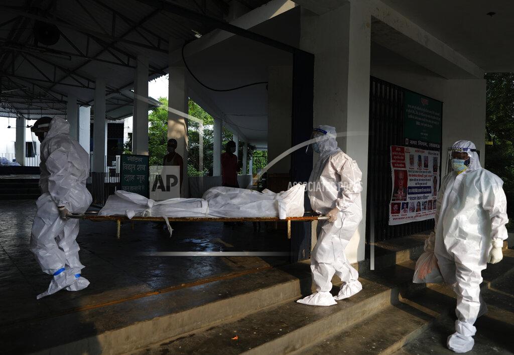 Rajesh Kumar Singh Health workers wearing personnel protection equipment carry the body of a COVID-19 victim for cremation in Lucknow, India, Saturday, Sept. 12, 2020. India's coronavirus cases are now the second-highest in the world and only behind the United States. (AP Photo/Rajesh Kumar Singh)