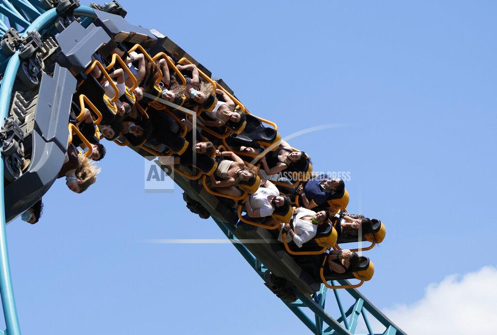 Alessandra Tarantino Visitors enjoy a ride on a roller coaster at Cinecitta World amusement park in the outskirts of Rome in the day of its reopening, Thursday, June 17, 2021. Amusement parks have been closed since Oct. 25 2020, when Italy's second national lockdown started. (AP Photo/Alessandra Tarantino)