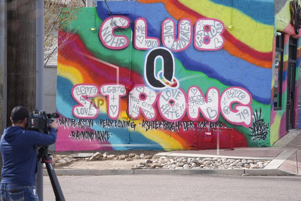David Zalubowski A television cameraman works near a tribute to the victims of a mass shooting at a gay nightclub painted on the side of a downtown commercial buiding Wednesday, Nov. 23, 2022, in Colorado Springs, Colo. (AP Photo/David Zalubowski)