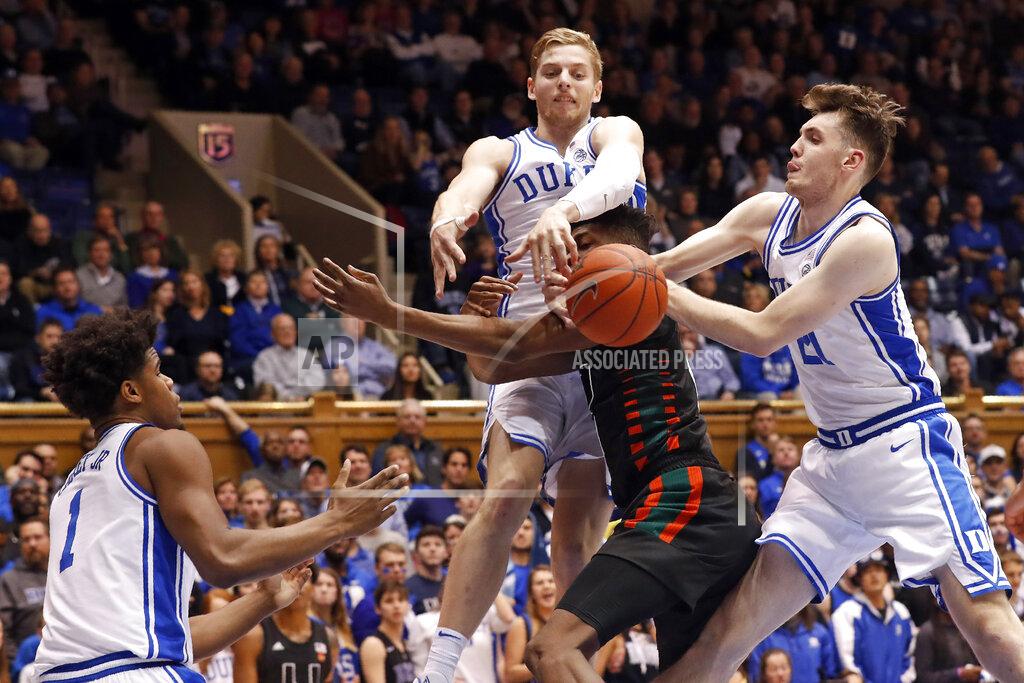 Gerry Broome Miami forward Anthony Walker is blocked by Duke forward Jack White and forward Matthew Hurt (21) while center Vernon Carey Jr. (1) looks on during the first half of an NCAA college basketball game in Durham, N.C., Tuesday, Jan. 21, 2020. (AP Photo/Gerry Broome)