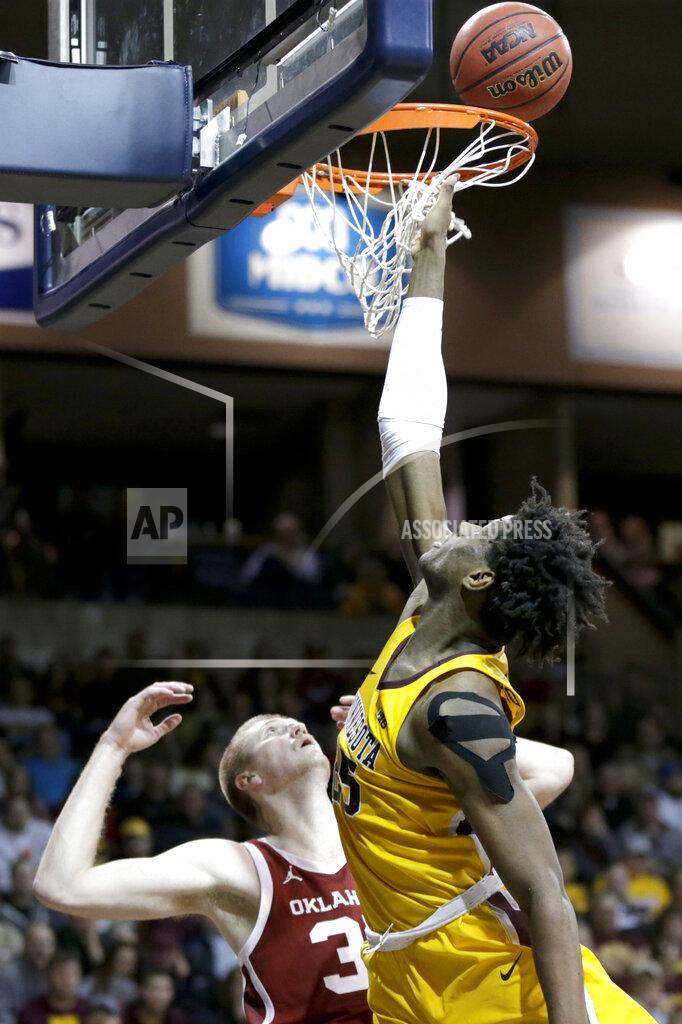 Nati Harnik Minnesota's Daniel Oturu, right, scores a basket against Oklahoma's Brady Manek (35) during the second half of an NCAA college basketball game in Sioux Falls, S.D., Saturday, Nov. 9, 2019. Oklahoma won 71-62. (AP Photo/Nati Harnik)