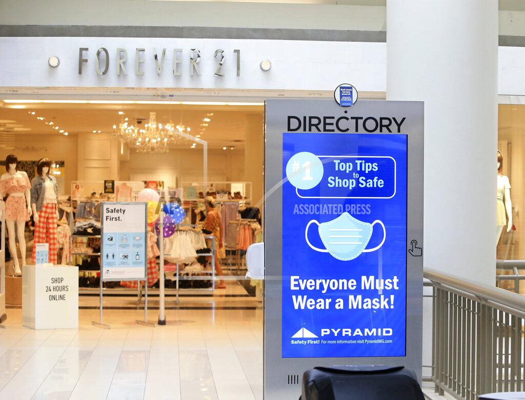 A sign on mask usage covers the disabled interactive directory display at the Poughkeepsie Galleria mall in Poughkeepsie, N.Y., Friday, July 10, 2020. Lohud.com reports that New York's enclosed malls were allowed to open on Friday after being shuttered due to the coronavirus. They are required to upgrade their ventilation systems and enforce social distancing to the greatest extent possible. (Patrick Oehler/The Journal via AP)