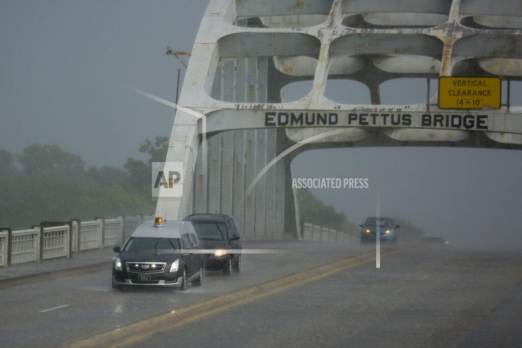 Brynn Anderson A hearse carrying the casket of the late Rep. John Lewis, D-Ga., drives over the Edmund Pettus Bridge Saturday, July 25, 2020, in route to the Brown Chapel in Selma, Ala. Lewis, who carried the struggle against racial discrimination from Southern battlegrounds of the 1960s to the halls of Congress, died Friday, July 17, 2020. (AP Photo/Brynn Anderson)