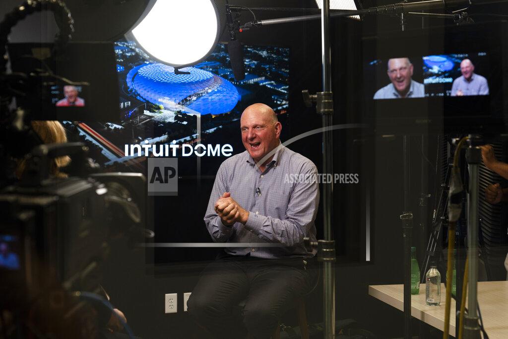Jae C. Hong Los Angeles Clippers owner Steve Ballmer talks to a reporter during an interview as a rendering of the proposed arena for the Clippers appears on a display behind him Thursday, Sept. 16, 2021, in Los Angeles. (AP Photo/Jae C. Hong)