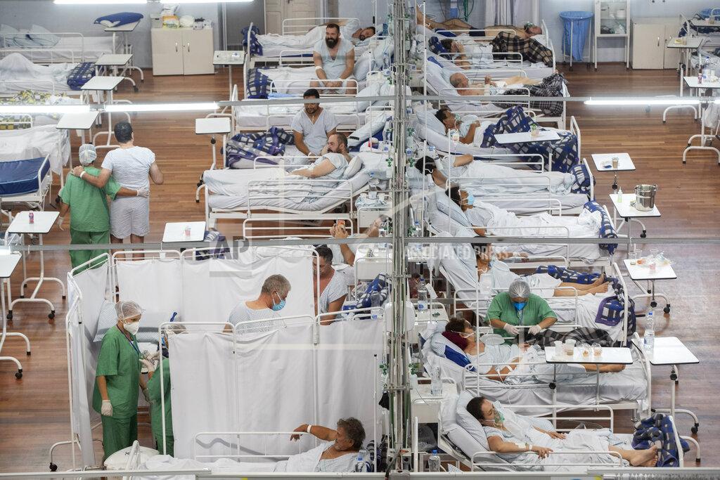 Andre Penner FILE - In this March 4, 2021 file photo, COVID-19 patients rest in a field hospital built inside a sports coliseum in Santo Andre, on the outskirts of Sao Paulo, Brazil. COVID-19's spread accelerated in 2021, causing more deaths in the first four months of 2021 than in all of 2020. (AP Photo/Andre Penner, File)