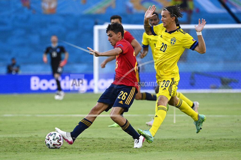 Pierre Philippe Marcou Spain's Pedri, left, challenges for the ball with Sweden's Kristoffer Olsson during the Euro 2020 soccer championship group E match between Spain and Sweden at La Cartuja stadium in Seville, Monday, June 14, 2021. (AP Photo/Pierre Philippe Marcou, Pool)