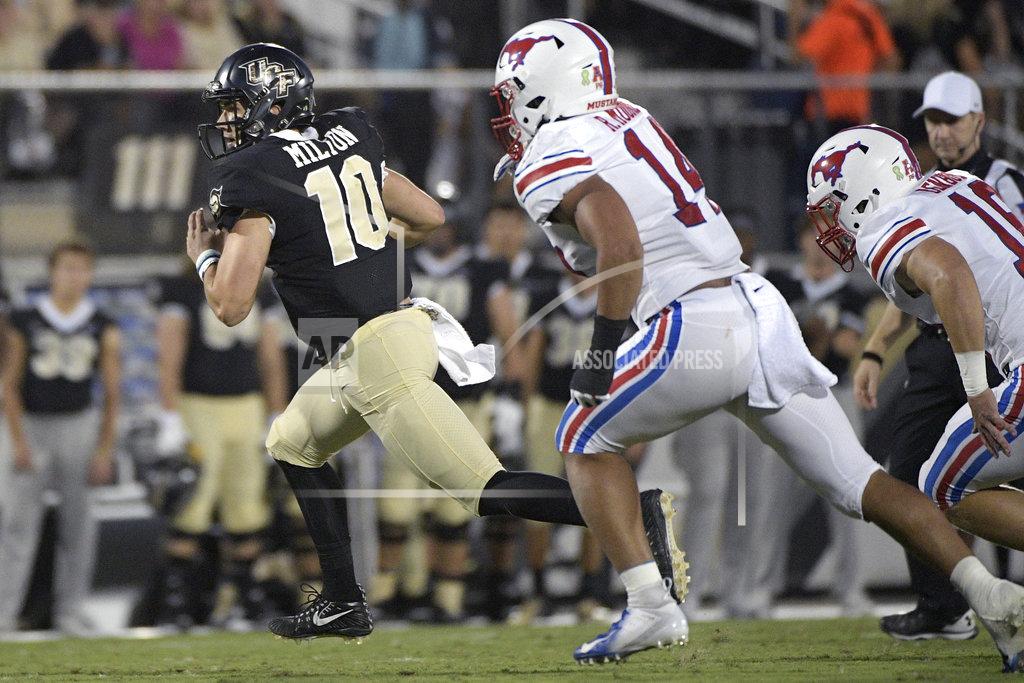 Phelan M. Ebenhack Central Florida quarterback McKenzie Milton (10) scrambles for yardage in front of SMU linebacker Richard Moore (14) and linebacker Trevor Denbow (16) during the first half of an NCAA college football game Saturday, Oct. 6, 2018, in Orlando, Fla. (AP Photo/Phelan M. Ebenhack)