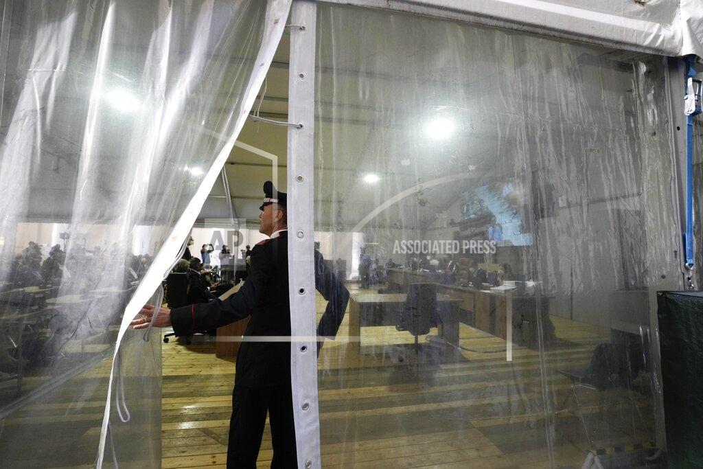 Antonio Calanni An Italian Carabiniere, paramilitary police officer, enters inside the court room during the opening of the first hearing of the trial for the Morandi bridge collapse at the Genoa's Palace of Justice, Thursday, July 7, 2022. Forty-three people were killed when a large stretch of the Morandi Bridge broke off, August 14, 2018, on the eve of one of Italy's biggest vacation holidays. (AP Photo/Antonio Calanni)