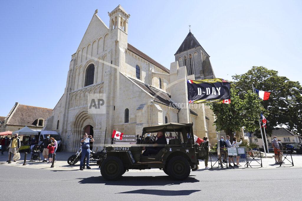 David Vincent World War II history enthusiasts parade in WWII vehicles in Ouistreham, Normandy, Saturday June, 5 2021 on the eve of 77th anniversary of the assault that helped bring an end to World War II. While France is planning to open up to vaccinated visitors starting next week, that comes too late for the D-Day anniversary. So for the second year in a row, most public commemoration events have been cancelled. A few solemn ceremonies have been maintained, in the presence of dignitaries and a few guests only. (AP Photo/David Vincent)