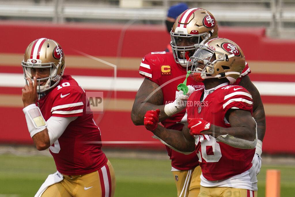 Tony Avelar San Francisco 49ers running back Jerick McKinnon, right, celebrates with quarterback Jimmy Garoppolo, left, and offensive tackle Trent Williams after scoring a touchdown against the Arizona Cardinals during the second half of an NFL football game in Santa Clara, Calif., Sunday, Sept. 13, 2020. (AP Photo/Tony Avelar)