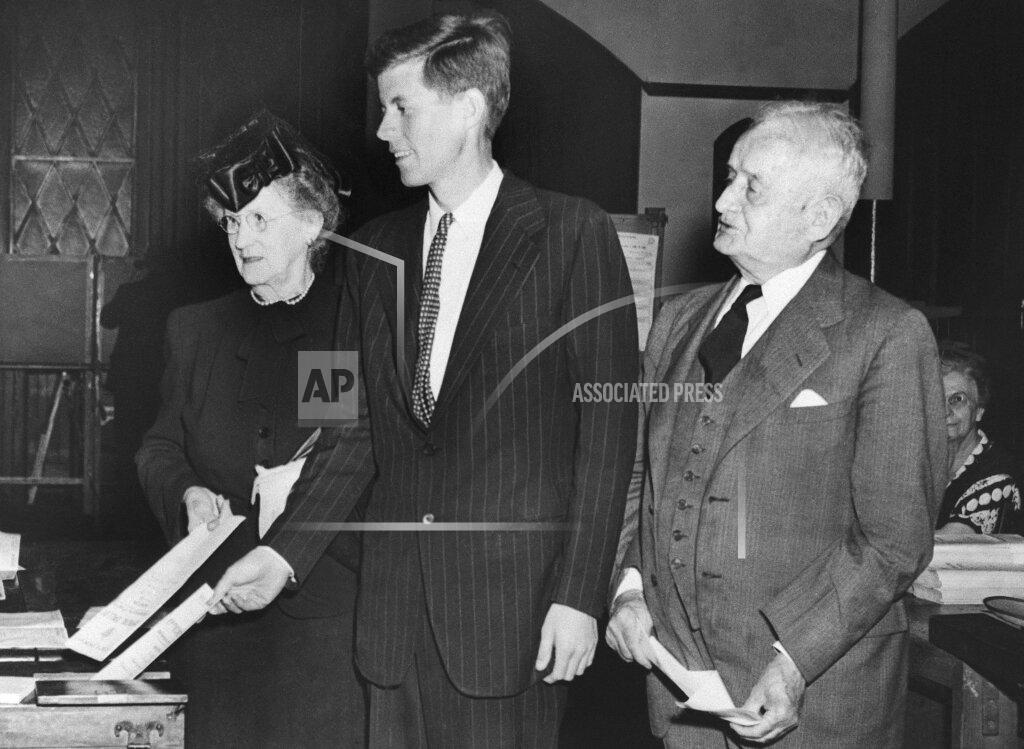 Uncredited FILE - In this June 18, 1946, file photo, Democrat congressional candidate John F. Kennedy, center, casts his vote beside his grandparents Mary Josephine "Josie" Fitzgerald, left, and former Boston Mayor John F. "Honey Fitz" Fitzgerald, during a primary election in Boston. Fitzgerald served two terms as Boston's mayor in the early 1900s. (AP Photo, File)