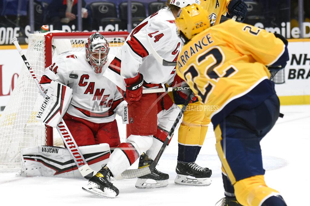 Mark Zaleski Carolina Hurricanes goaltender Petr Mrazek (34) blocks a shot by Nashville Predators defenseman David Farrance (22) during the second period of an NHL hockey game Monday, May 10, 2021, in Nashville, Tenn. (AP Photo/Mark Zaleski)