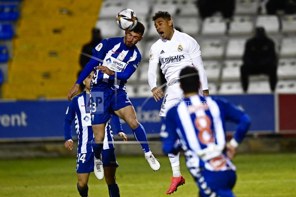 Jose Breton Alcoyano's Jose Solbes, left and Real Madrid's Mariano Diaz jump for a high ball during a Spanish Copa del Rey round of 32 soccer match between Alcoyano and Real Madrid at the El Collao stadium in Alcoy, Spain, Wednesday Jan. 20, 2021. (AP Photo/Jose Breton)