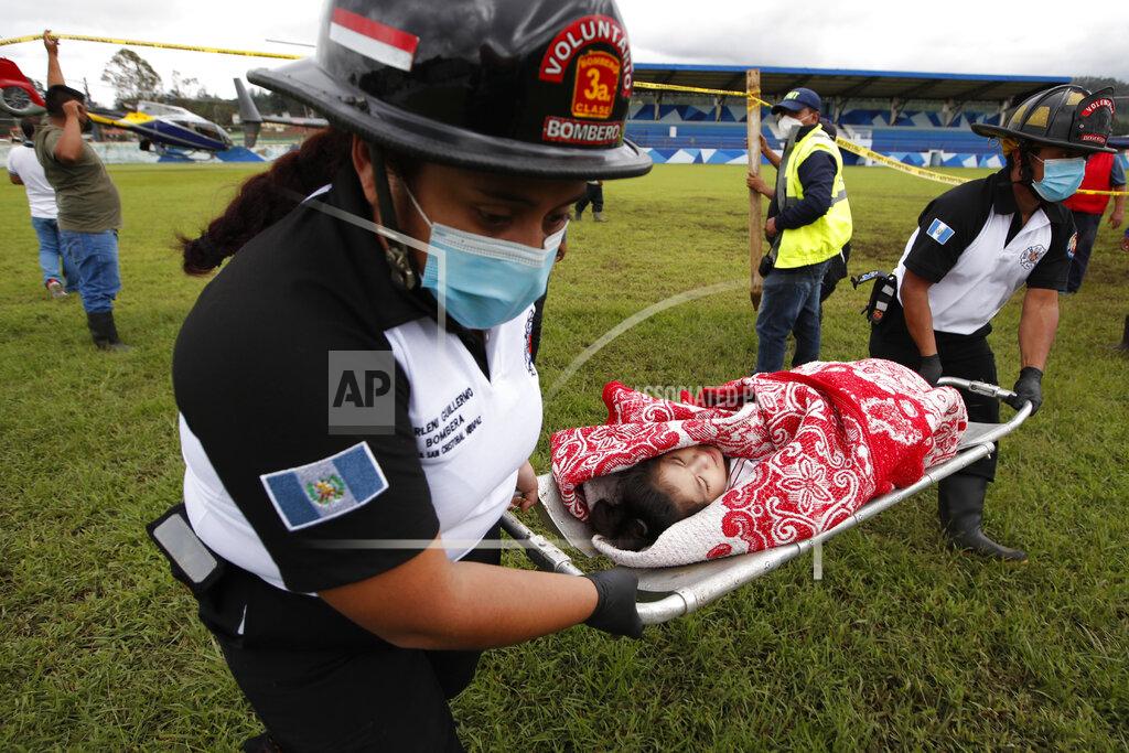 Moises Castillo A girl rescued from the zone where residents are believed buried by a massive, rain-fueled landslide, is carried on a stretcher to a waiting ambulance during a search and rescue operation, in San Cristobal Verapaz, Saturday, Nov. 7, 2020, in the aftermath of Tropical Storm Eta. (AP Photo/Moises Castillo)